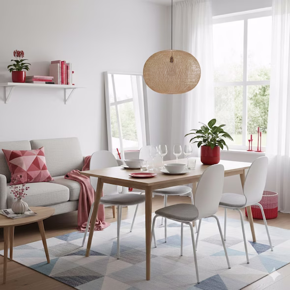 Comedor moderno de estilo escandinavo con mesa de madera y decoración en tonos neutros y rojos.